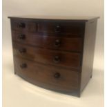 A 19TH CENTURY MAHOGANY AND CROSS BANDED MINIATURE BOW FRONTED CHEST OF TWO SHORT ABOVE THREE LONG