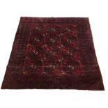 AN AFGHAN WOOLLEN RUG The central lozenges on a plum ground. (233cm x 197cm) Condition: good