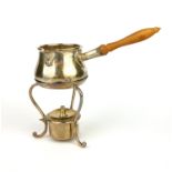 AN EDWARDIAN SILVER AND IVORY BULBOUS BRANDY WARMER With a single spout and turned ivory handle,