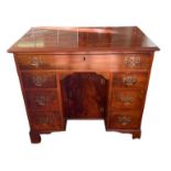 A 19TH CENTURY MAHOGANY KNEEHOLE DESK, with an arrangement of seven drawers centered by a