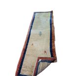 A 20TH CENTURY GABBEH WOOLLEN RUNNER The oatmeal ground contained within running borders. (242cm x