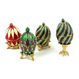 A COLLECTION OF FOUR 20TH CENTURY GILT METAL AND ENAMEL OVAL TRINKET EGGS With hinged lids and