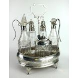 A GEORGIAN SILVER AND CUT CRYSTAL GLASS FIVE BOTTLE CRUET SET Classical form with fine engraved