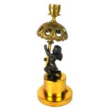 A 19TH CENTURY BRONZE ORMOLU FIGURAL CANDLESTICK, having an engraved Greek key design to sconce on