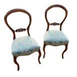 A PAIR OF VICTORIAN WALNUT BALLOON BACK CHAIRS, with carved and pierced back rails overstuffed