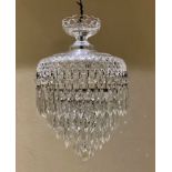 AN EARLY/MID 20TH CENTURY GLASS THREE TIER CHANDELIER Hung with crystal drops. (50cm) Condition: