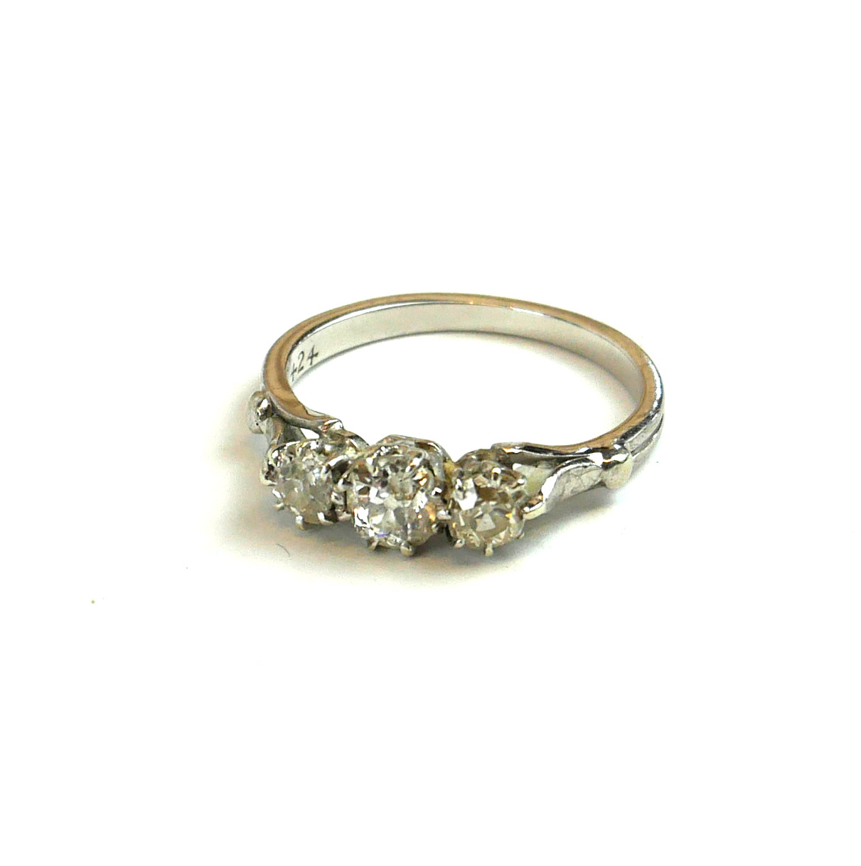 A VINTAGE WHITE METAL AND DIAMOND THREE STONE RING Graduated round cut stones (size P). (approx