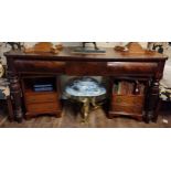 A GEORGIAN MAHOGANY BUFFET With three drawers, raised on heavy turned a reeded legs.