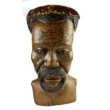 AN AFRICAN HARDWOOD DRUM With antelope skin on a carved facial base. (54cm) Condition: good