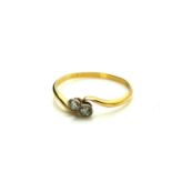 A VINTAGE 18CT GOLD AND DIAMOND TWIST RING Two round cut diamonds in a half twist design. (approx