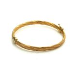 A VINTAGE 9CT GOLD BANGLE Having a textured rope twist design, marked 'Italy 375'. (approx 6g)