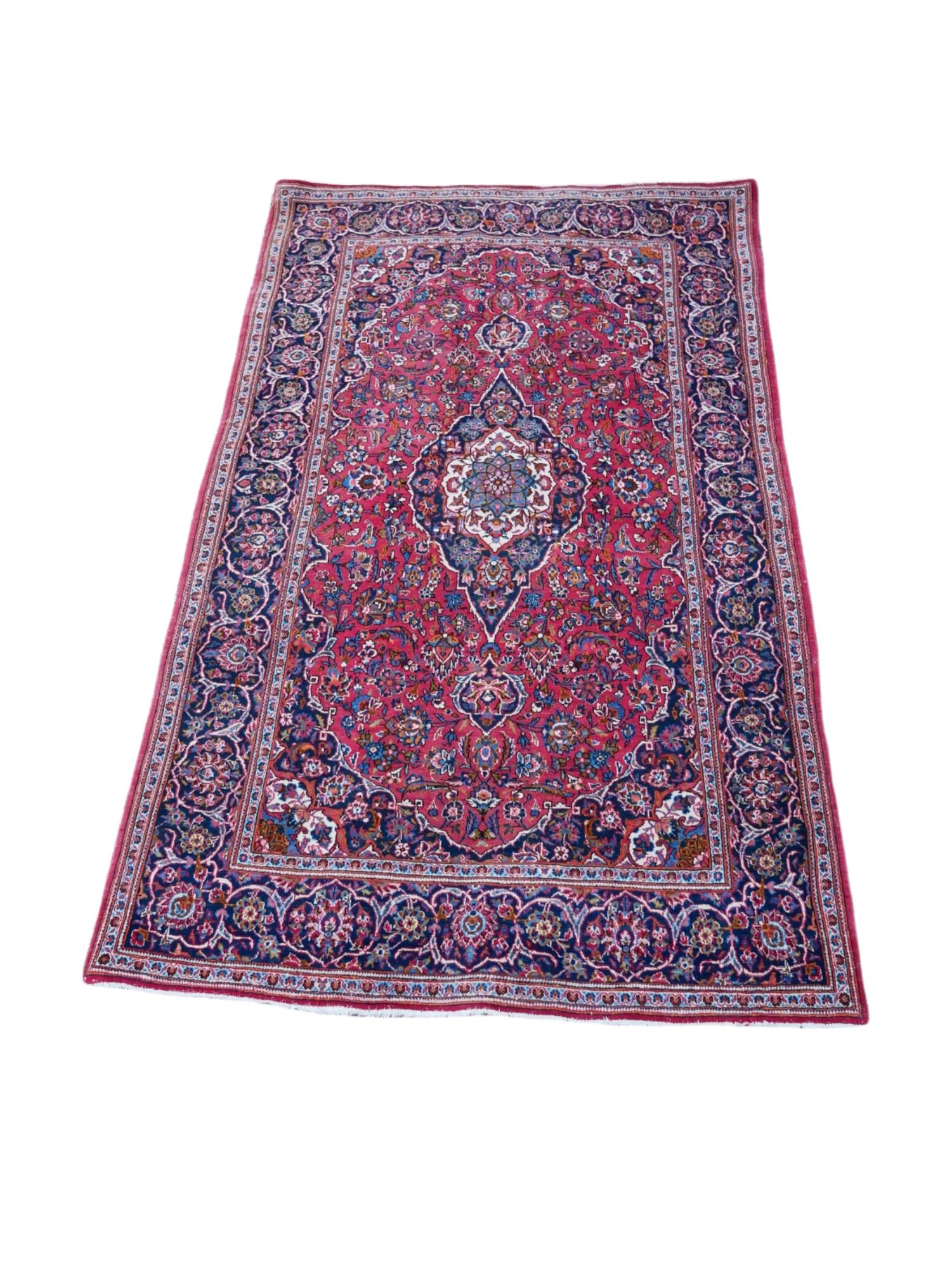 A PERSIAN RUG OF TRADITIONAL DESIGN The central floral field contained within running borders. (