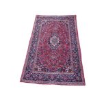 A PERSIAN RUG OF TRADITIONAL DESIGN The central floral field contained within running borders. (