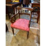 A WILLIAM IV MAHOGANY OPEN ARMCHAIR With carved central back rail, over scroll arms and