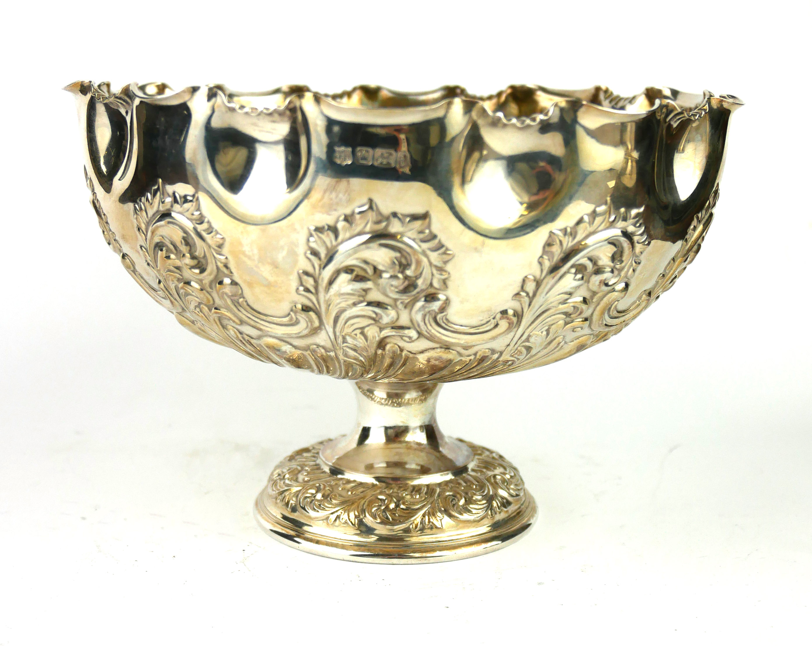 AN EDWARDIAN SILVER PEDESTAL BOWL Having a scrolled edge and embossed fluted decoration,