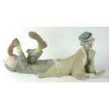 LLADRO, A LARGE MATT GLAZED PORCELAIN FIGURE Titled 'Clown with Ball', in a reclining pose with a