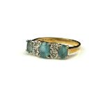 A 9CT GOLD, AQUAMARINE AND DIAMOND RING The three oval cut stones interspersed with diamonds, in a
