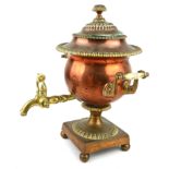 AN EARLY 19TH CENTURY COPPER SAMOVAR Twin handles with turned ivory mounts, brass spout and ball