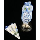 A 19TH CENTURY CONTINENTAL BLUE AND WHITE POTTERY STATUE OF AN OWL With green glass eyes, along with