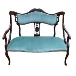 AN ART NOUVEAU PERIOD MAHOGANY AND MARQUETRY INLAID TWO SEAT SETTEE Green velvet upholstery, on