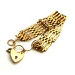 A VINTAGE 9CT GOLD GATE BRACELET The five pierced links with heart form clasp. (approx 17cm, 13g)