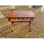 A VICTORIAN GOTHIC OAK SIDE TABLE, with ribbed molded top above a shaped apron, raised on lyre