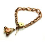 A VICTORIAN 9CT ROSE GOLD BRACELET Uniform oval links with heart form clasp and watch fob marked '
