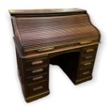 AN EARLY 20TH CENTURY OAK TAMBOUR DESK The 'S' shaped folding front, enclosing a fitted interior