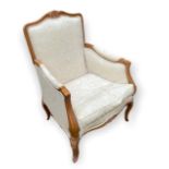 A FRENCH DESIGN LIMEWOOD FRAMED ARMCHAIR With carved shell crest, upholstered seat and back, on