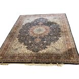 A LARGE PERSIAN RUG OF CARPET PROPORTIONS With central floral field contained within running