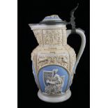 VILLEROY & BOCH, METTLACH, AN EARLY 20TH CENTURY STONEWARE STEIN/WINE EWER Decorated with raised