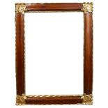 AN ITALIAN MAHOGANY AND PARCEL GILT MIRROR Cornered with florets. (116cm x 87cm) Condition: good