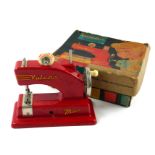 VULCAN MINOR, A VINTAGE TINPLATE CHILD'S TOY SEWING MACHINE Red painted finish, patent design number