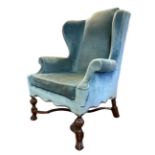 AN EARLY 20TH CENTURY WILLIAM AND MARY STYLE WING ARMCHAIR With scroll back and over scroll arms