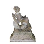 AFTER THE ANTIQUE, A RECONSTITUTED STONE STATUE Of a putti holding a wheat sheaf reclining on a '
