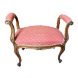 A VICTORIAN CARVED WALNUT AND PARCEL GILT LADIES STOOL With upholstered arms and seat, on cabriole