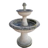 AN EARLY/MID CENTURY RECONSTITUTED STONE GARDEN FOUNTAIN With acorn finial above two graduated scale