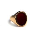 A VINTAGE 9CT GOLD AND BLOODSTONE GENT'S SIGNET RING The oval bloodstone set in a 9ct gold shank. (