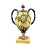 MINTON, A 19TH CENTURY PORCELAIN CAMPANA FORM PEDESTAL VASE AND COVER MODELLED WITH GRAPES AND