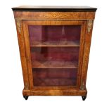 A VICTORIAN WALNUT AND MARQUETRY INLAID PEER CABINET The single door enclosing shelves flanked by