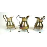 A COLLECTION OF THREE GEORGIAN AND LATER SILVER CREAM JUGS The single handle with tripod legs and