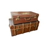 A LARGE EARLY 20TH CENTURY BRITISH MADE TRAVELLING TRUNK Opening to reveal a fitted cotton interior,