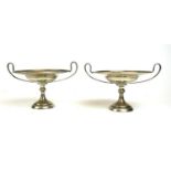 A PAIR OF EARLY 20TH CENTURY SILVER TAZZAS Twin handles with shallow bowls, on circular feet,