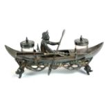 A VICTORIAN SILVER PLATE AND GLASS FIGURAL INKSTAND MODELLED AS AN ORSMAN IN ROWING BOAT Set with