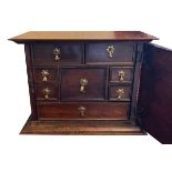 A 17TH CENTURY AND LATER WALNUT AND MAHOGANY SPICE BOX The single door enclosing an arrangement of