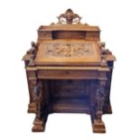 AN IMPRESSIVE CARVED 19TH CENTURY WALNUT DESK The shell carved cartouche above two drawers and an