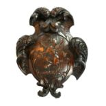 A 19TH CENTURY OAK CARVED FAMILY CREST PANEL OF A STANDING GRIFFIN Surrounded by organic form