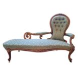 A HIGH VICTORIAN WALNUT SPOON BACK CHAISE LOUNGE In a green button back fabric upholstery, with