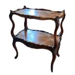 A 19TH CENTURY WALNUT TWO TIER ÉTAGÈRE The shaped galleried back and supports having carved