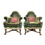 A PAIR OF WILLIAM AND MARY STYLE WALNUT HUMPBACK ARMCHAIRS With over-scroll arms above a shaped